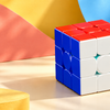Speed cube against a colourful coral, yellow and blue background